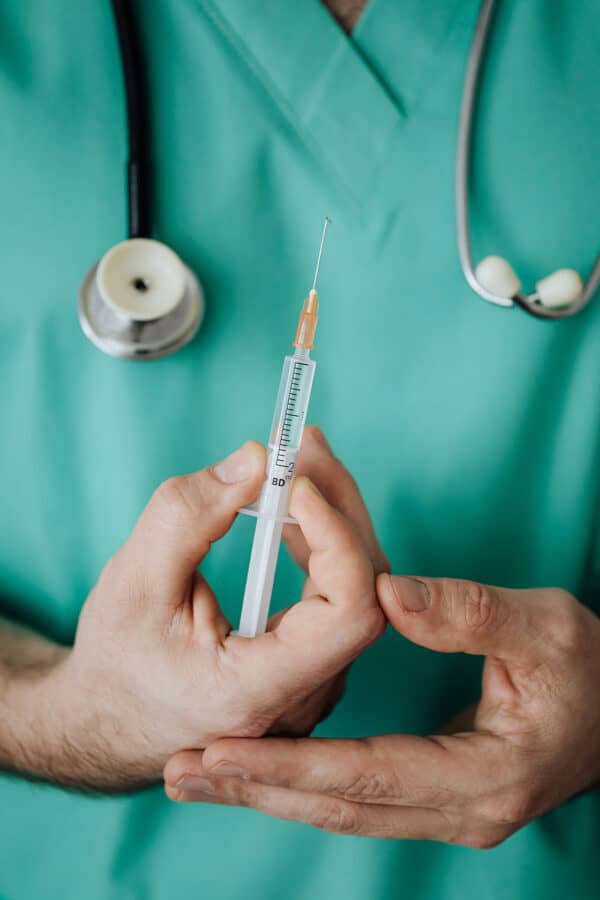 Image of doctor holding an injection needle