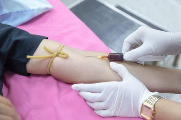 Image of person getting blood drawn with a needle