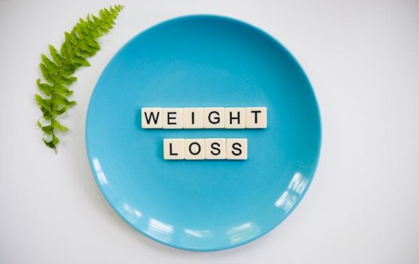 Image of a blue plate with the words weight loss spelled out on it